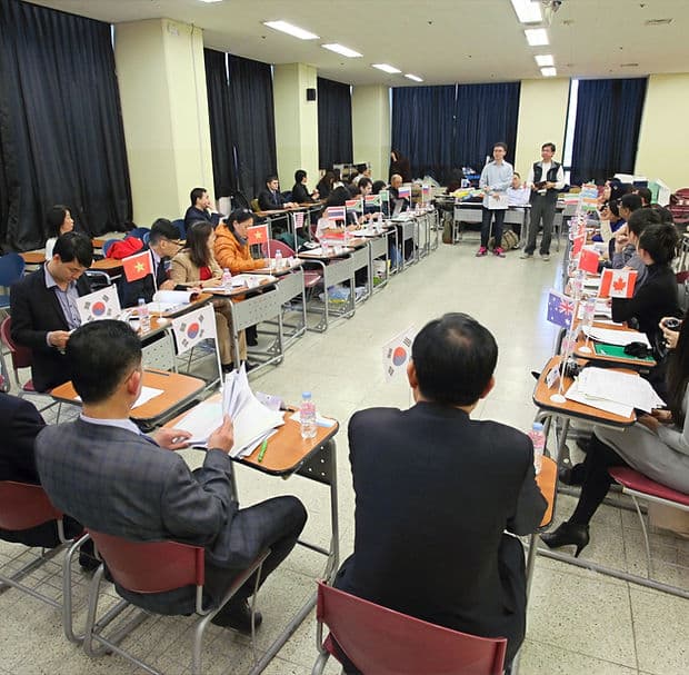 PAMA Global member delegates seated at an international meeting with national flags