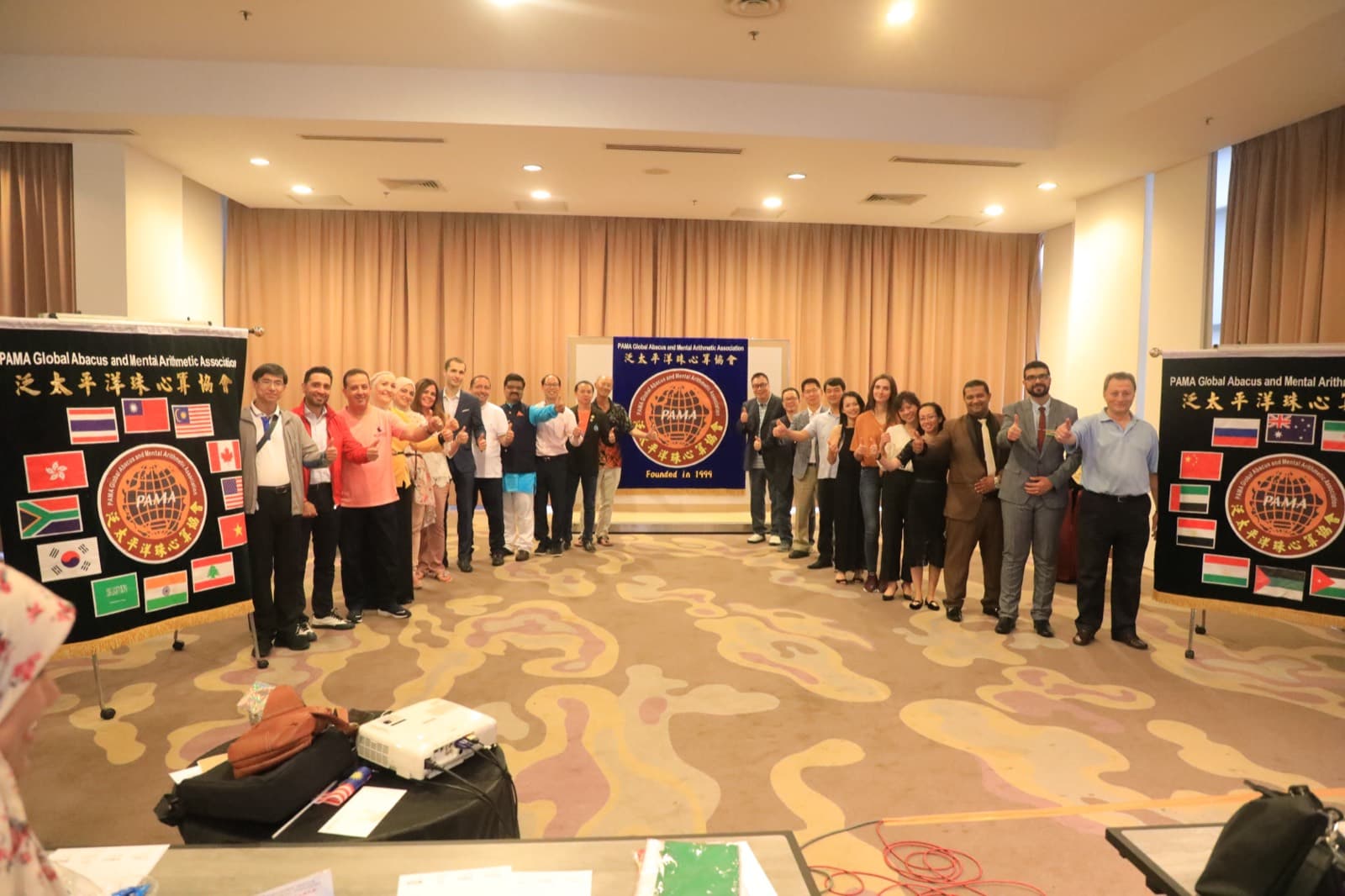 A large hall of students sitting a PAMA competition paper
