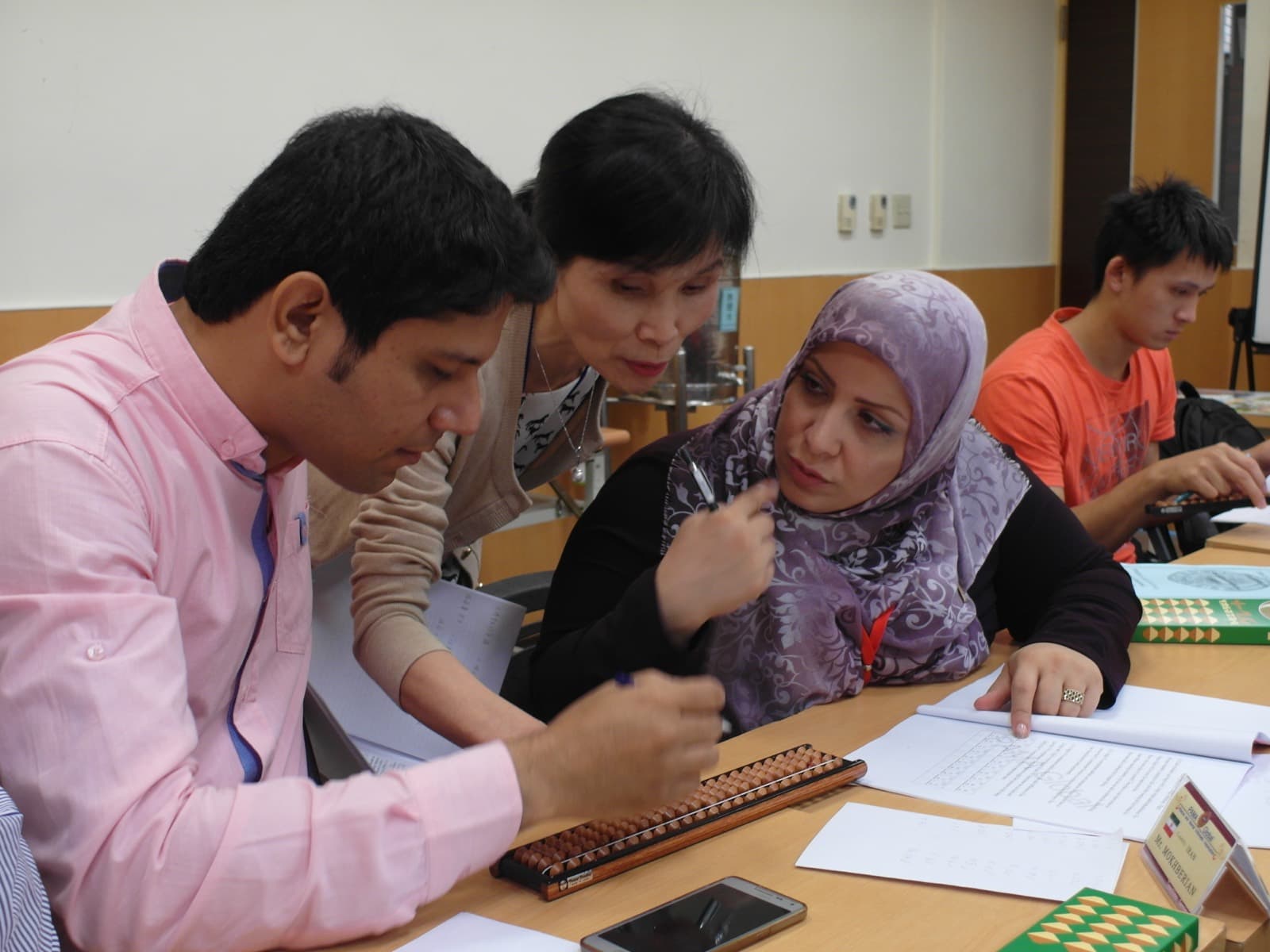 Teachers from several countries practising on abaci at a training seminar